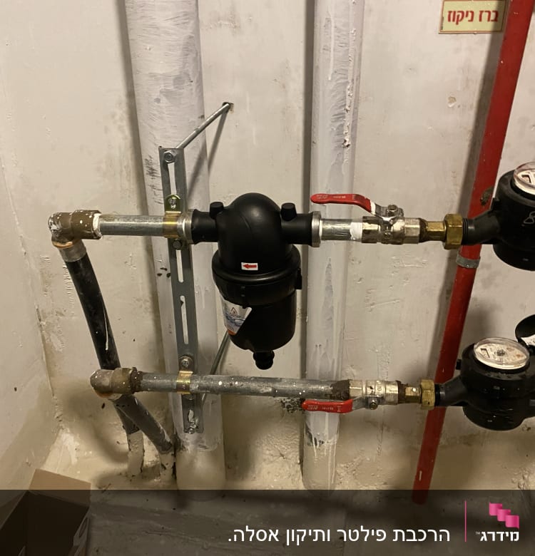 צינורות מים עם ברזים ומדי מים בחדר שירות
